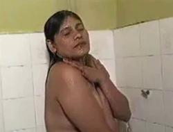 Indian milf shows her boobs while having shower.
